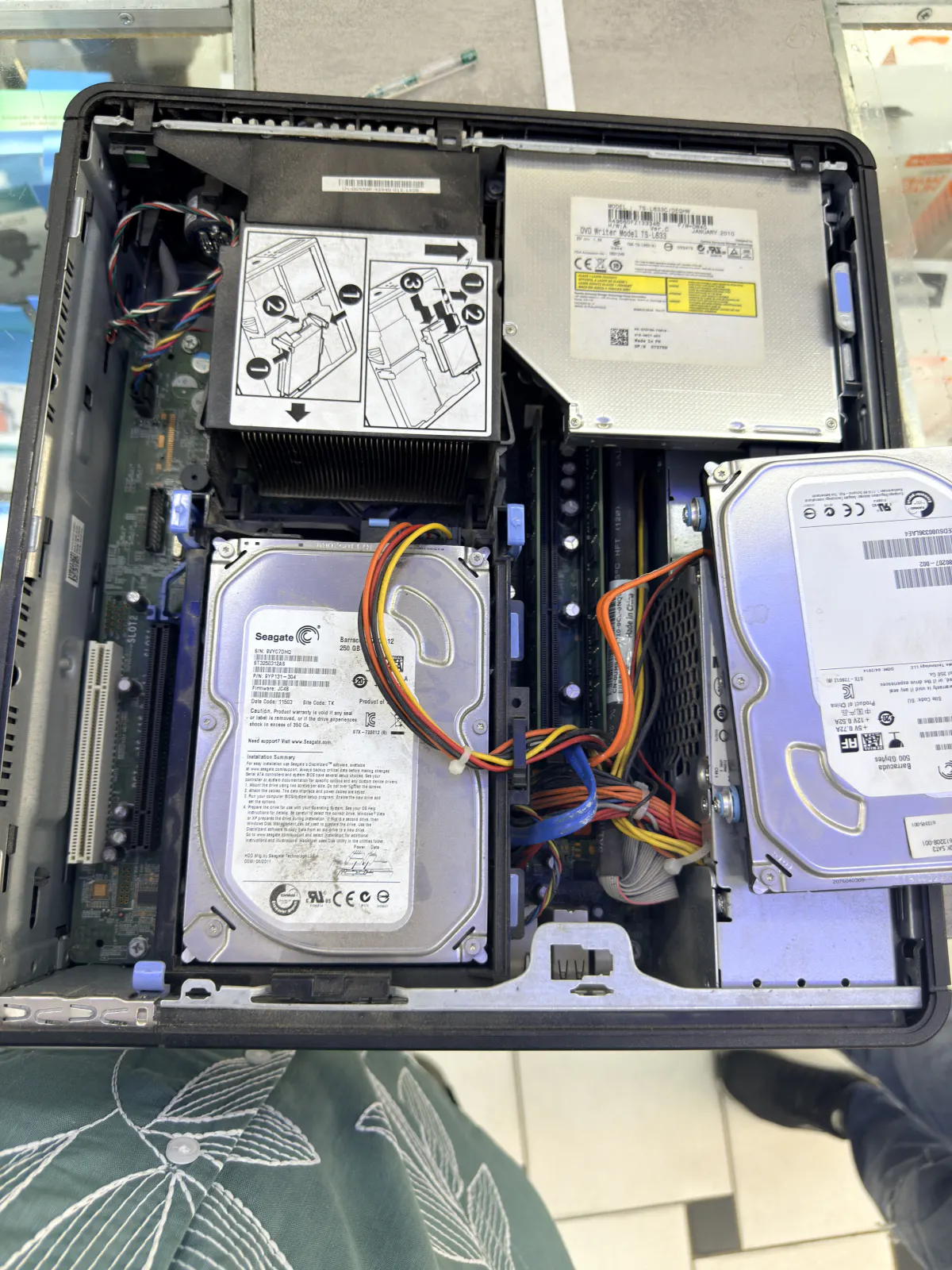 Interior of a Dell tower with two Seagate hard drives, a DVD drive and SATA cabling visible